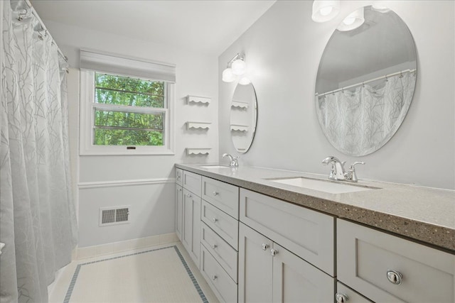 1558 Sylvan Glen Rd, Okemos, MI 48864 - full bath featuring double vanity, baseboards, and tile patterned floors