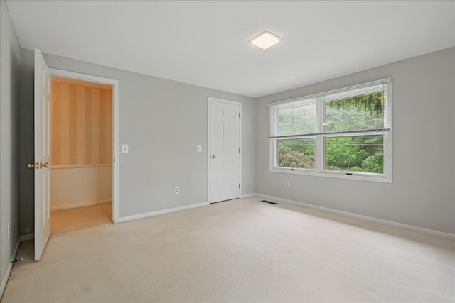 1558 Sylvan Glen Rd, Okemos, MI 48864 - unfurnished bedroom with light colored carpet and baseboards