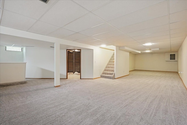 1558 Sylvan Glen Rd, Okemos, MI 48864 - basement with a drop ceiling, carpet flooring, stairs, and baseboards