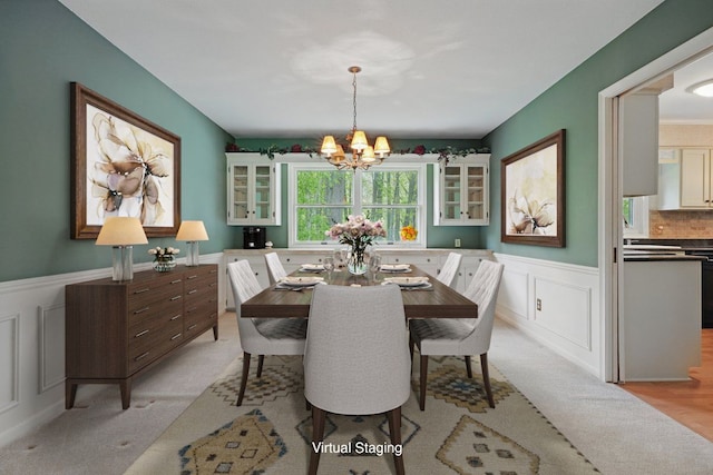 1558 Sylvan Glen Rd, Okemos, MI 48864 - dining room featuring a chandelier, a wainscoted wall, light carpet, and a decorative wall