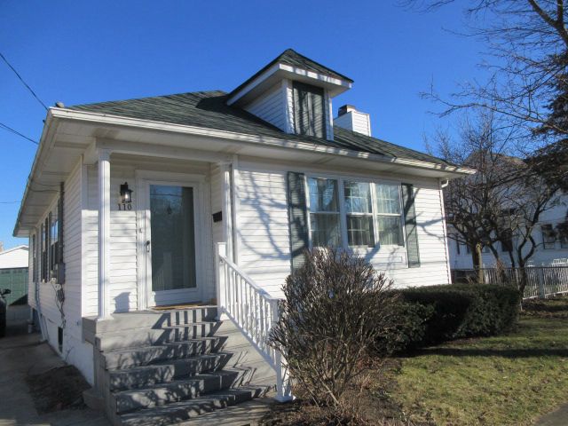 110 N 1st St, Holly, MI 48442 - view of front of house with a chimney
