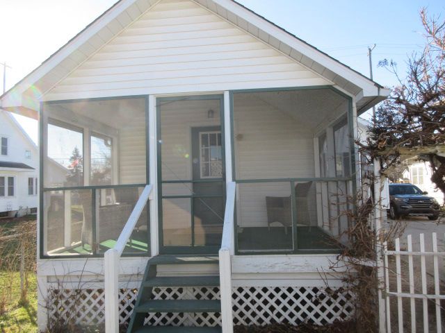 110 N 1st St, Holly, MI 48442 - rear view of house featuring a sunroom and fence