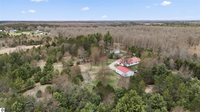 2426 E 48 1/2 Rd, Cadillac, MI 49601 - aerial overview of property's location featuring a forest