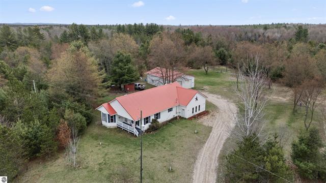 2426 E 48 1/2 Rd, Cadillac, MI 49601 - view from above of property with a heavily wooded area