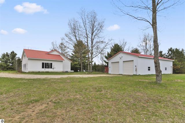 2426 E 48 1/2 Rd, Cadillac, MI 49601 - view of green lawn with a garage and an outdoor structure