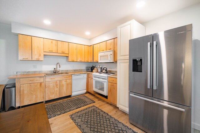 27607 Elba Dr, Grosse Ile, MI 48138 - kitchen featuring white appliances, a sink, light countertops, light wood-type flooring, and recessed lighting