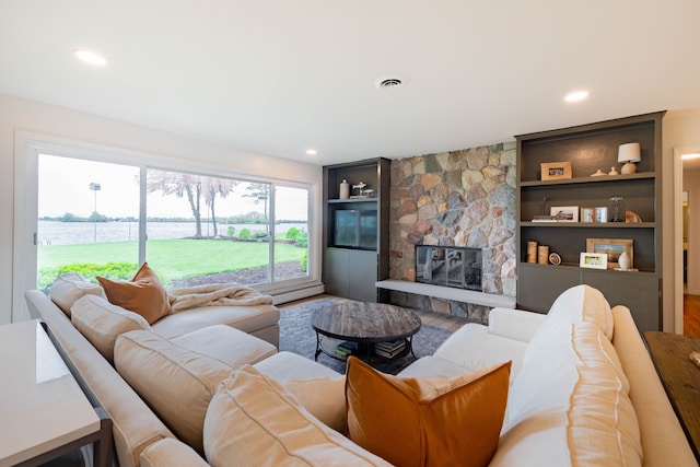 27607 Elba Dr, Grosse Ile, MI 48138 - living area with wood finished floors, built in shelves, a fireplace, a water view, and recessed lighting