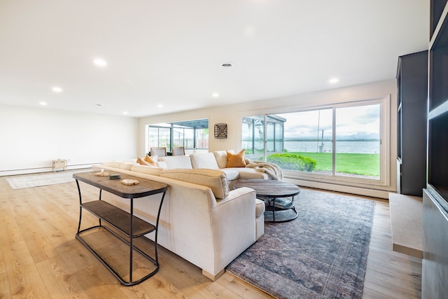 27607 Elba Dr, Grosse Ile, MI 48138 - living room featuring a baseboard radiator, light wood-style floors, recessed lighting, and a water view