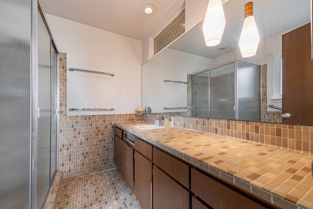 27607 Elba Dr, Grosse Ile, MI 48138 - full bathroom with tile walls, a stall shower, vanity, tile patterned flooring, and wainscoting