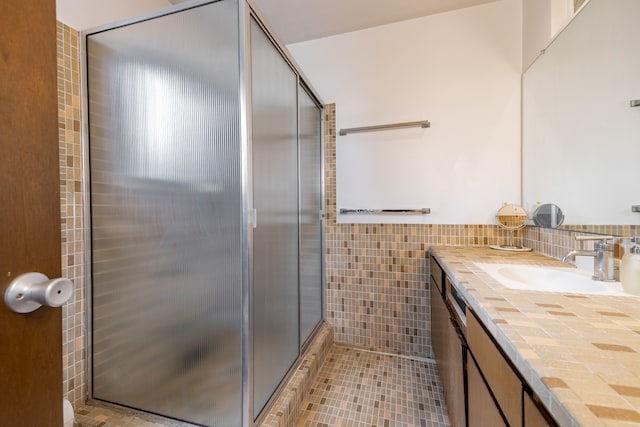 27607 Elba Dr, Grosse Ile, MI 48138 - full bathroom with tile walls, a stall shower, vanity, tile patterned flooring, and wainscoting