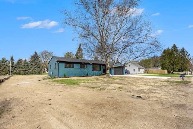 38501 Winkler St, Harrison Township, MI 48045 - view of front of house featuring dirt driveway and a garage
