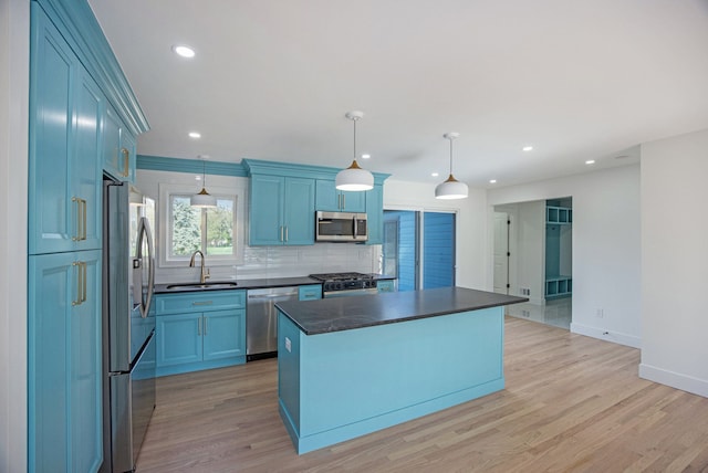38501 Winkler St, Harrison Township, MI 48045 - kitchen with appliances with stainless steel finishes, a sink, dark countertops, backsplash, and light wood-type flooring