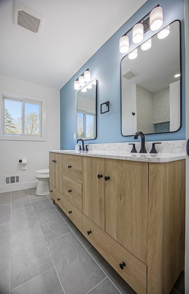 38501 Winkler St, Harrison Township, MI 48045 - bathroom featuring double vanity, plenty of natural light, toilet, and tile patterned floors