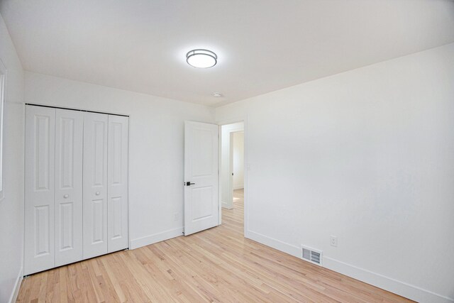 38501 Winkler St, Harrison Township, MI 48045 - unfurnished bedroom with baseboards, light wood-type flooring, and a closet