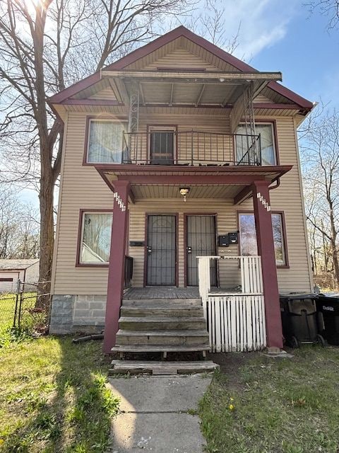 15779 Alden St, Detroit, MI 48238 - view of front of home featuring a balcony, a porch, and fence