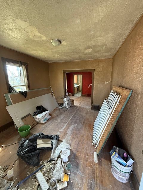 15779 Alden St, Detroit, MI 48238 - misc room featuring wood-type flooring and a textured ceiling