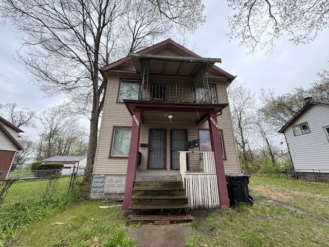 15779 Alden St, Detroit, MI 48238 - view of front of home featuring a porch, a balcony, and fence