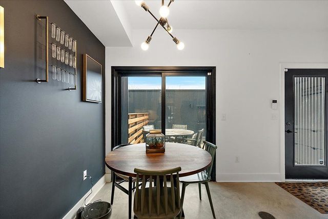 3313 Cochrane St, Detroit, MI 48208 - dining area featuring finished concrete floors, baseboards, and rail lighting