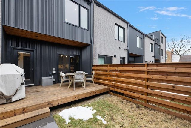 3313 Cochrane St, Detroit, MI 48208 - back of property featuring fence, a deck, and outdoor dining area