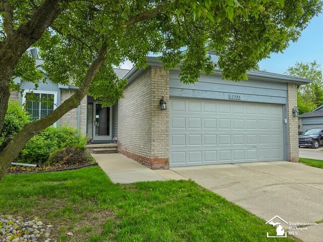 17795 Bobwhite Ct, Brownstown, MI 48192 - view of front of house featuring brick siding, concrete driveway, and an attached garage