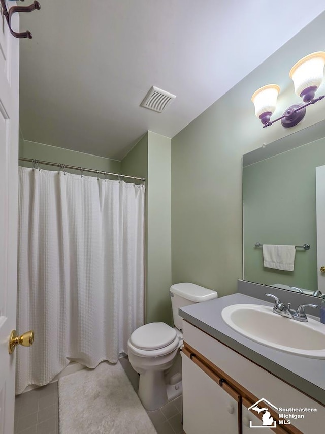 17795 Bobwhite Ct, Brownstown, MI 48192 - bathroom featuring tile patterned floors, vanity, and toilet