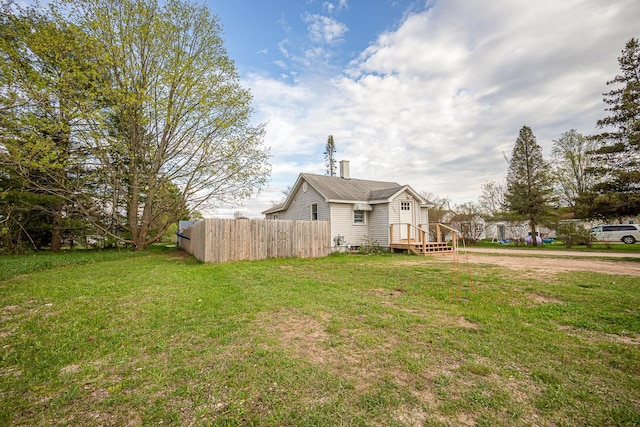 505 S Cherry St, Kalkaska, MI 49646 - view of side of property with a chimney