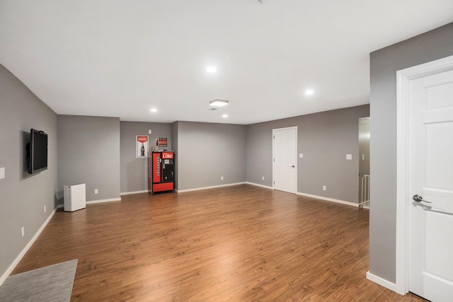 unfurnished living room featuring recessed lighting, baseboards, and wood finished floors