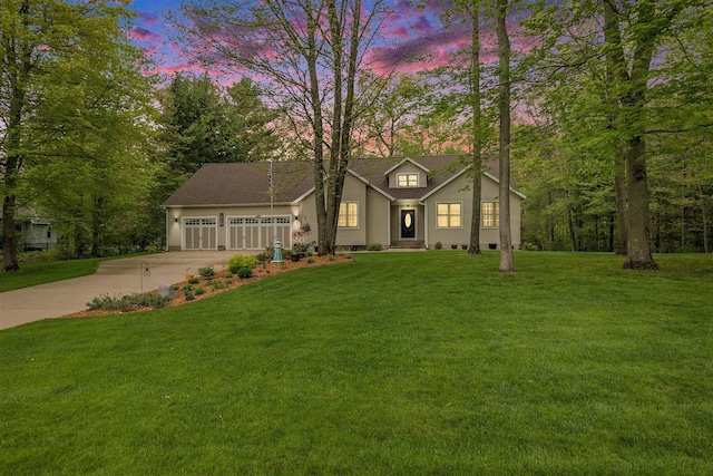 view of front of house featuring driveway, a garage, and a front yard