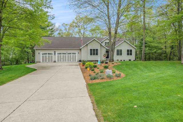 view of front of property featuring driveway, an attached garage, and a front yard
