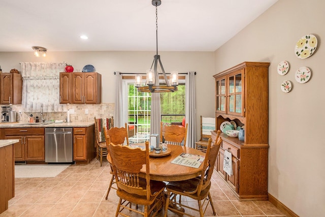 dining area with light tile patterned floors and a chandelier
