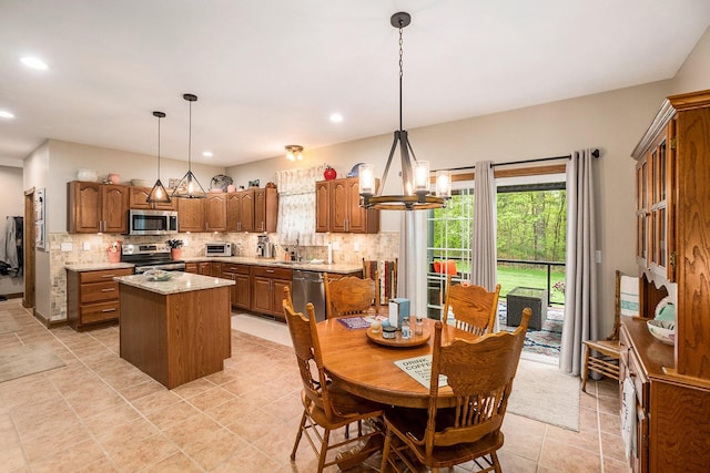 dining space with a chandelier, recessed lighting, and light tile patterned floors