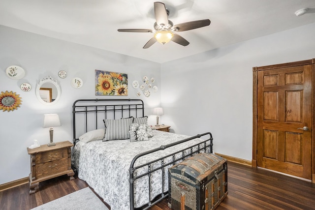 bedroom featuring baseboards, wood finished floors, and a ceiling fan