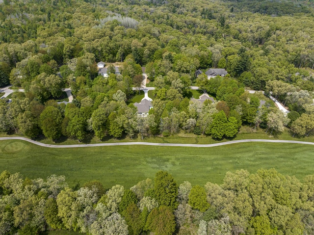 view of property location with a heavily wooded area