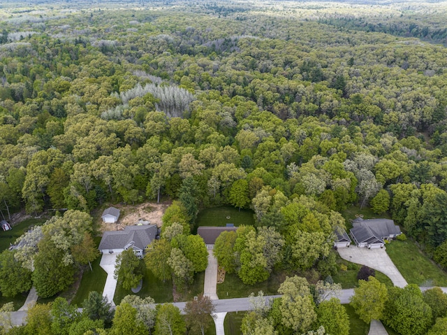 aerial view of property's location featuring a heavily wooded area