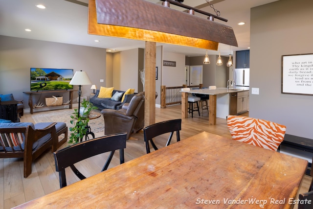 12640 Bucs Dr, Grand Haven, MI 49417 - dining room with light wood-type flooring and recessed lighting