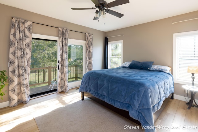 12640 Bucs Dr, Grand Haven, MI 49417 - bedroom featuring access to outside, wood finished floors, baseboards, and a ceiling fan