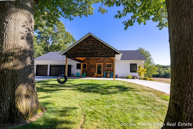 12640 Bucs Dr, Grand Haven, MI 49417 - view of front of property featuring a front lawn, an attached garage, a shingled roof, and covered porch