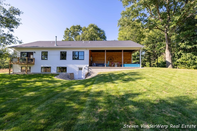 12640 Bucs Dr, Grand Haven, MI 49417 - rear view of house with a lawn
