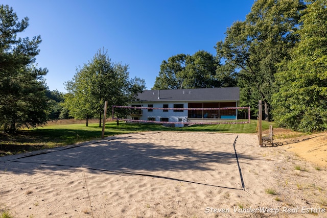 12640 Bucs Dr, Grand Haven, MI 49417 - view of property's community featuring volleyball court, driveway, and a yard