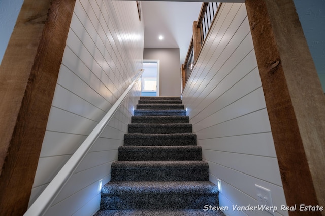 12640 Bucs Dr, Grand Haven, MI 49417 - stairway featuring recessed lighting and wood walls