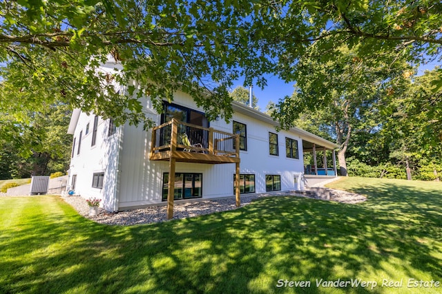 12640 Bucs Dr, Grand Haven, MI 49417 - rear view of house with a yard and a balcony