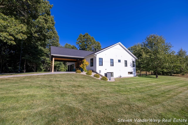 12640 Bucs Dr, Grand Haven, MI 49417 - view of front of property featuring an attached carport, a front yard, and driveway