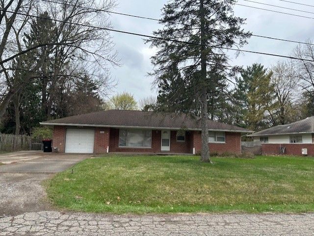 21383 Mada Ave, Southfield, MI 48075 - ranch-style home featuring an attached garage, driveway, and brick siding