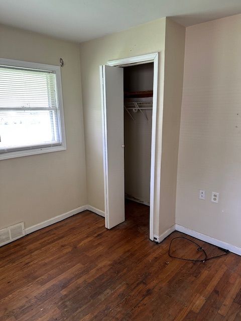 21383 Mada Ave, Southfield, MI 48075 - unfurnished bedroom with wood finished floors, baseboards, and a closet