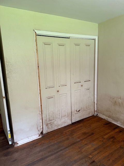 21383 Mada Ave, Southfield, MI 48075 - unfurnished bedroom with dark wood finished floors and a closet