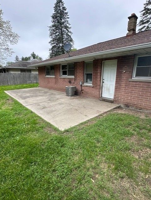 21383 Mada Ave, Southfield, MI 48075 - back of house with a patio area, brick siding, and a chimney