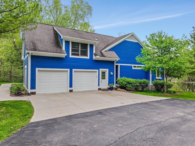 1355 W Buell Rd, Oakland, MI 48363 - traditional home featuring driveway, a shingled roof, and an attached garage