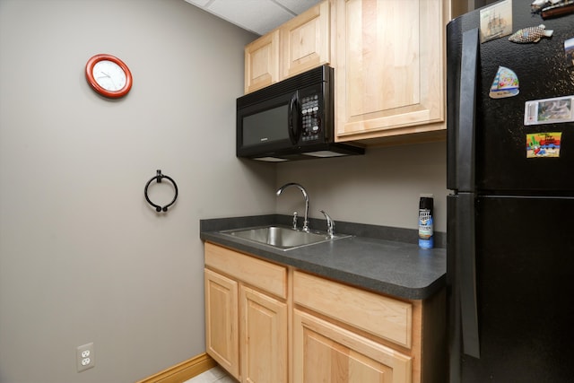 1355 W Buell Rd, Oakland, MI 48363 - kitchen featuring black appliances, a sink, light brown cabinetry, and dark countertops