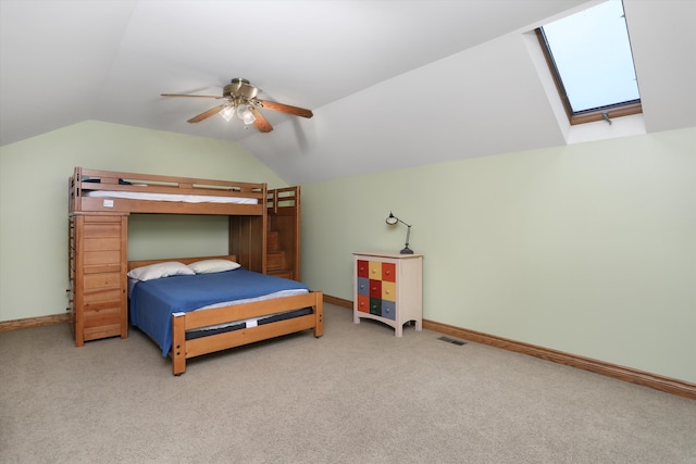 1355 W Buell Rd, Oakland, MI 48363 - carpeted bedroom with vaulted ceiling, baseboards, ceiling fan, and a skylight
