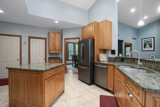 1355 W Buell Rd, Oakland, MI 48363 - kitchen with stainless steel appliances, a sink, light tile patterned floors, dark stone countertops, and a kitchen island